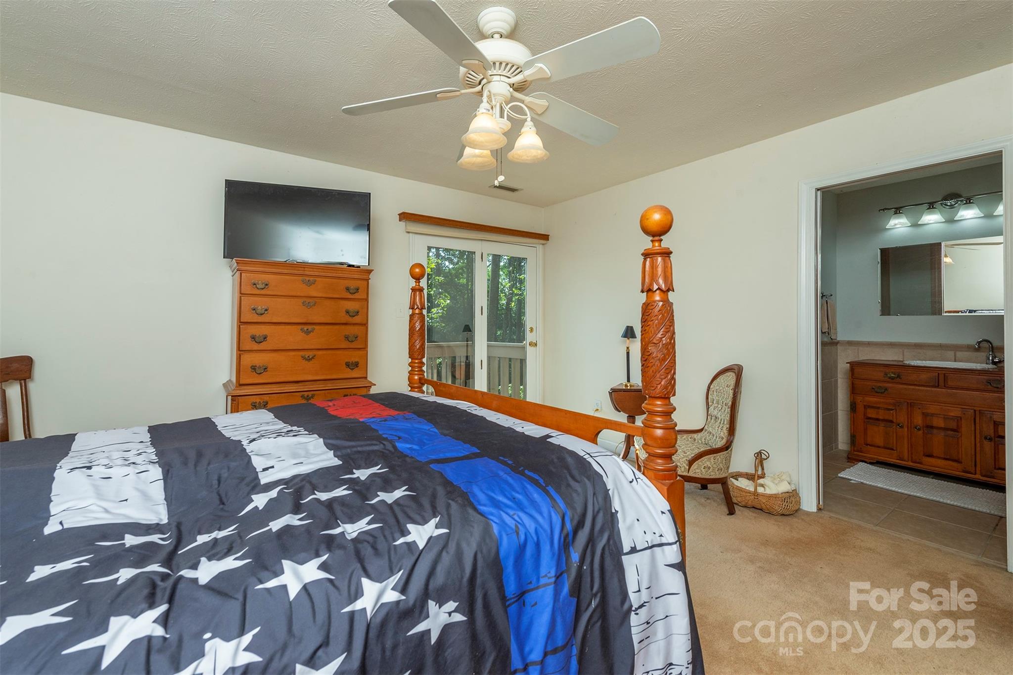 10 Chestnut Ridge Road Mills River, NC 28759 - Photo 19 of 47 a bedroom with a bed a dresser and flat screen tv