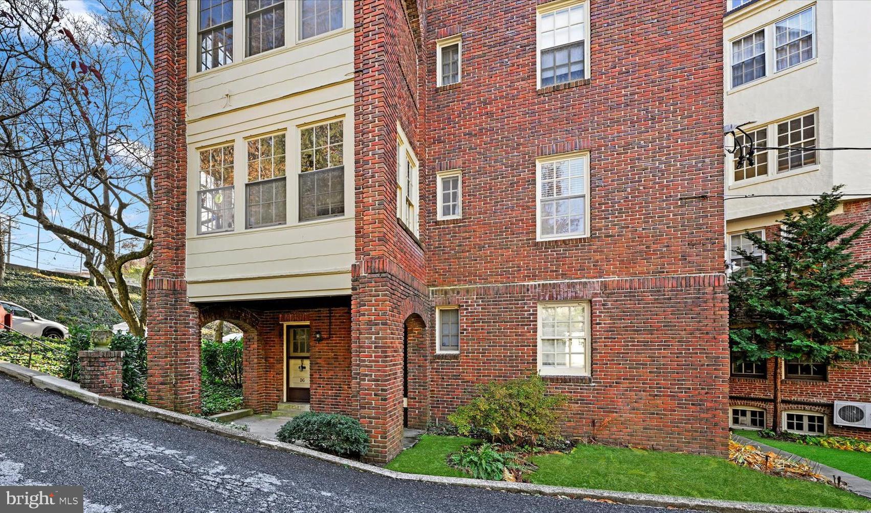 220 Stony Run Lane, Unit DG Baltimore, MD 21210 - Photo 11 of 13 a view of a brick building next to a yard
