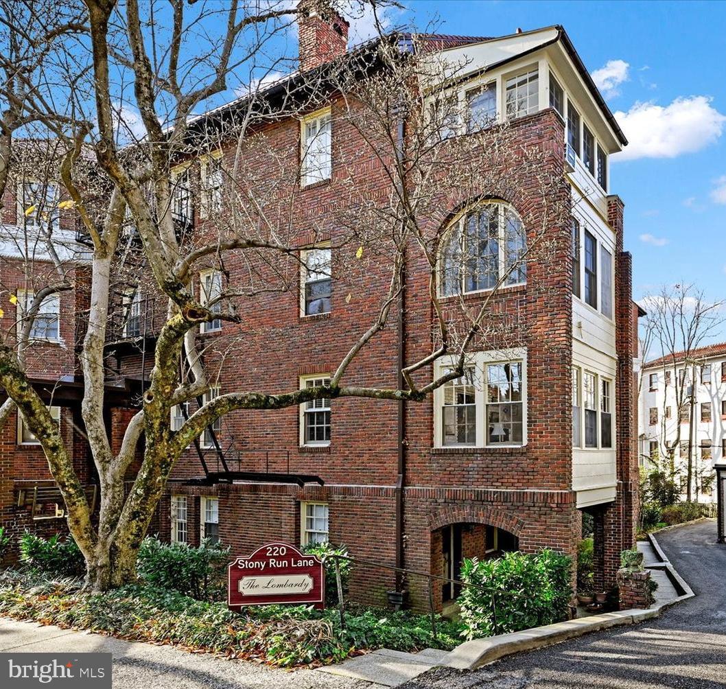 220 Stony Run Lane, Unit DG Baltimore, MD 21210 - Photo 12 of 13 a front view of a building with a garden and plants