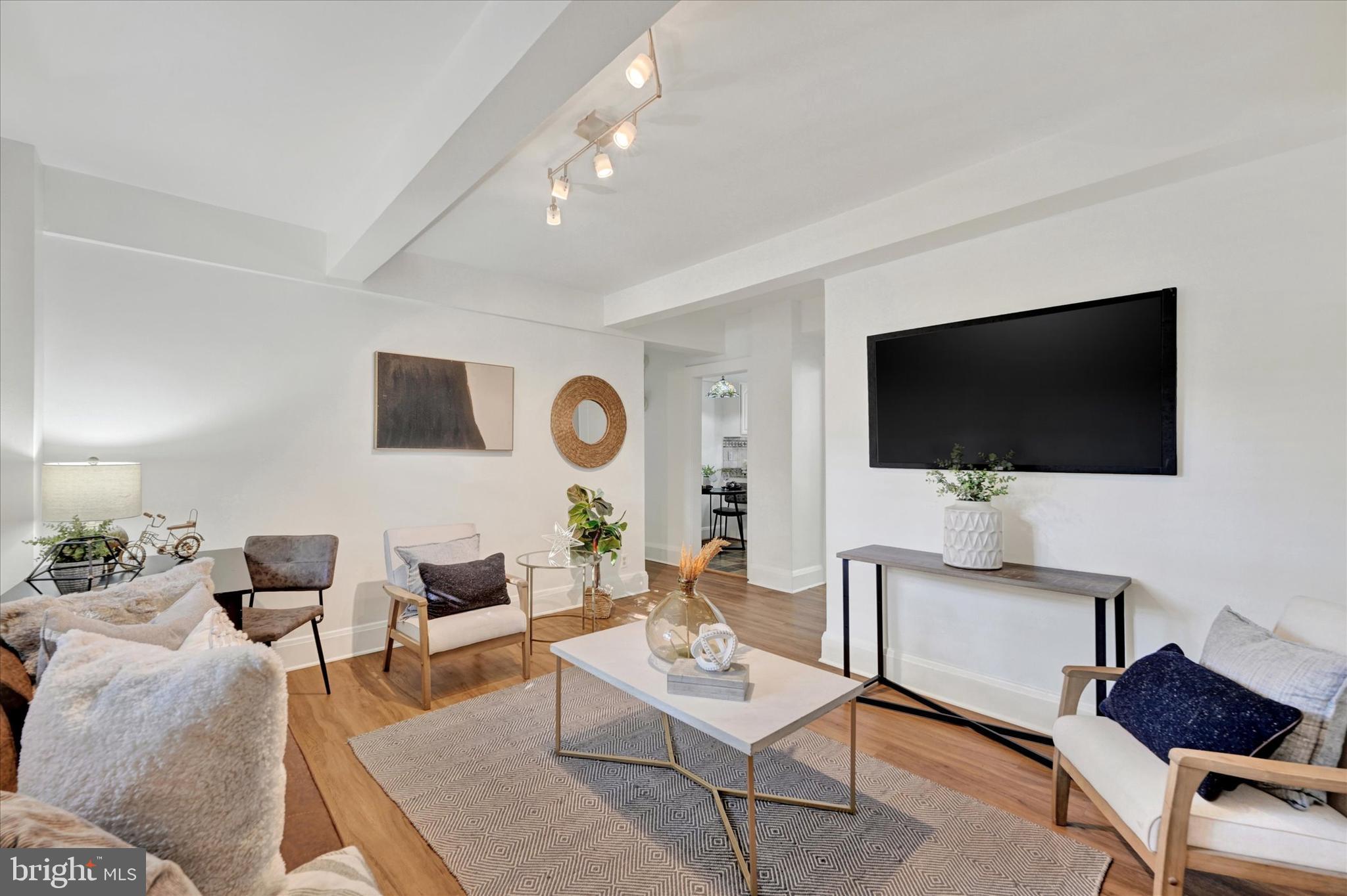 220 Stony Run Lane, Unit DG Baltimore, MD 21210 - Photo 3 of 13 a living room with furniture and a flat screen tv