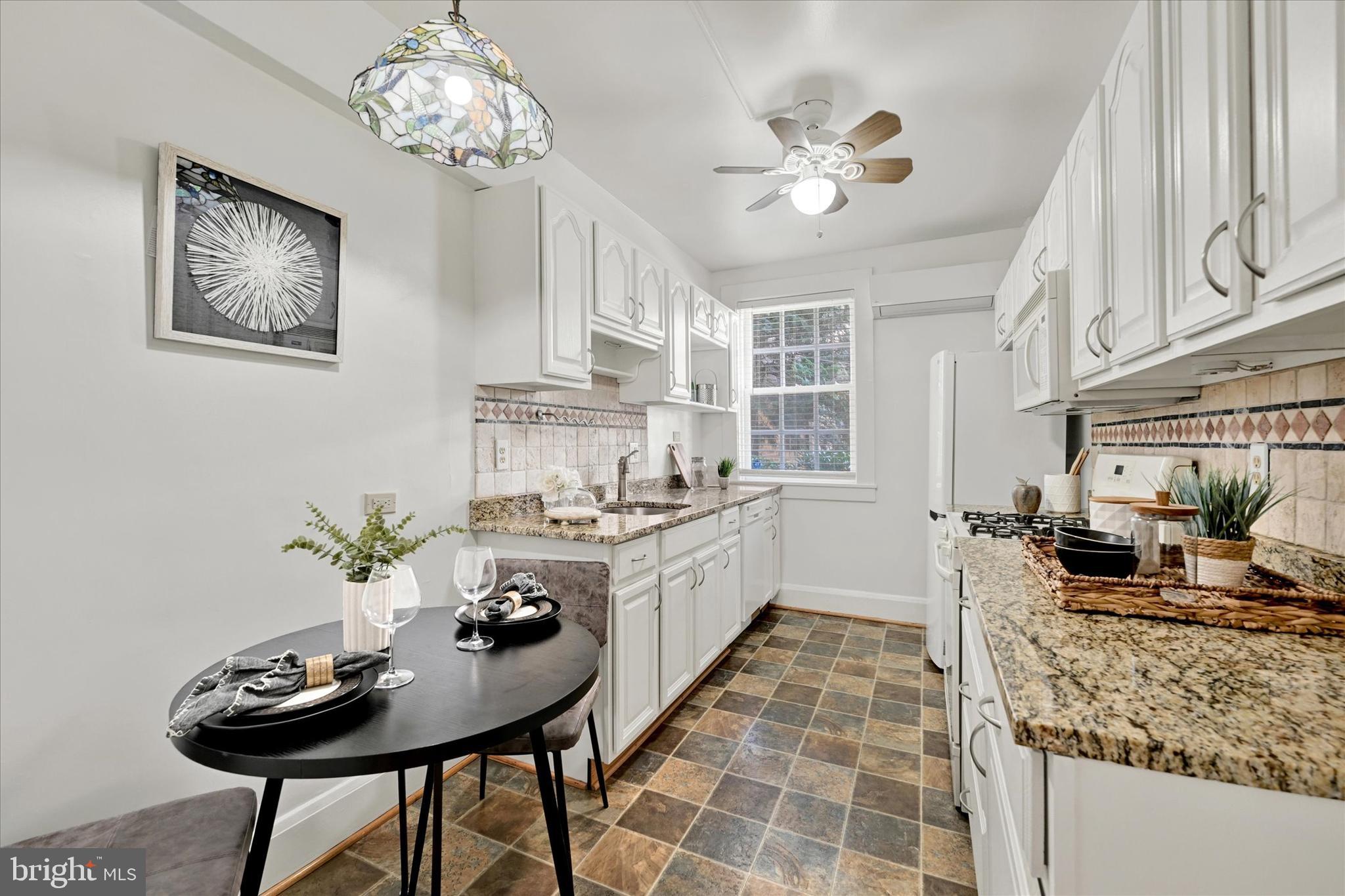 220 Stony Run Lane, Unit DG Baltimore, MD 21210 - Photo 4 of 13 a kitchen with a table and chairs