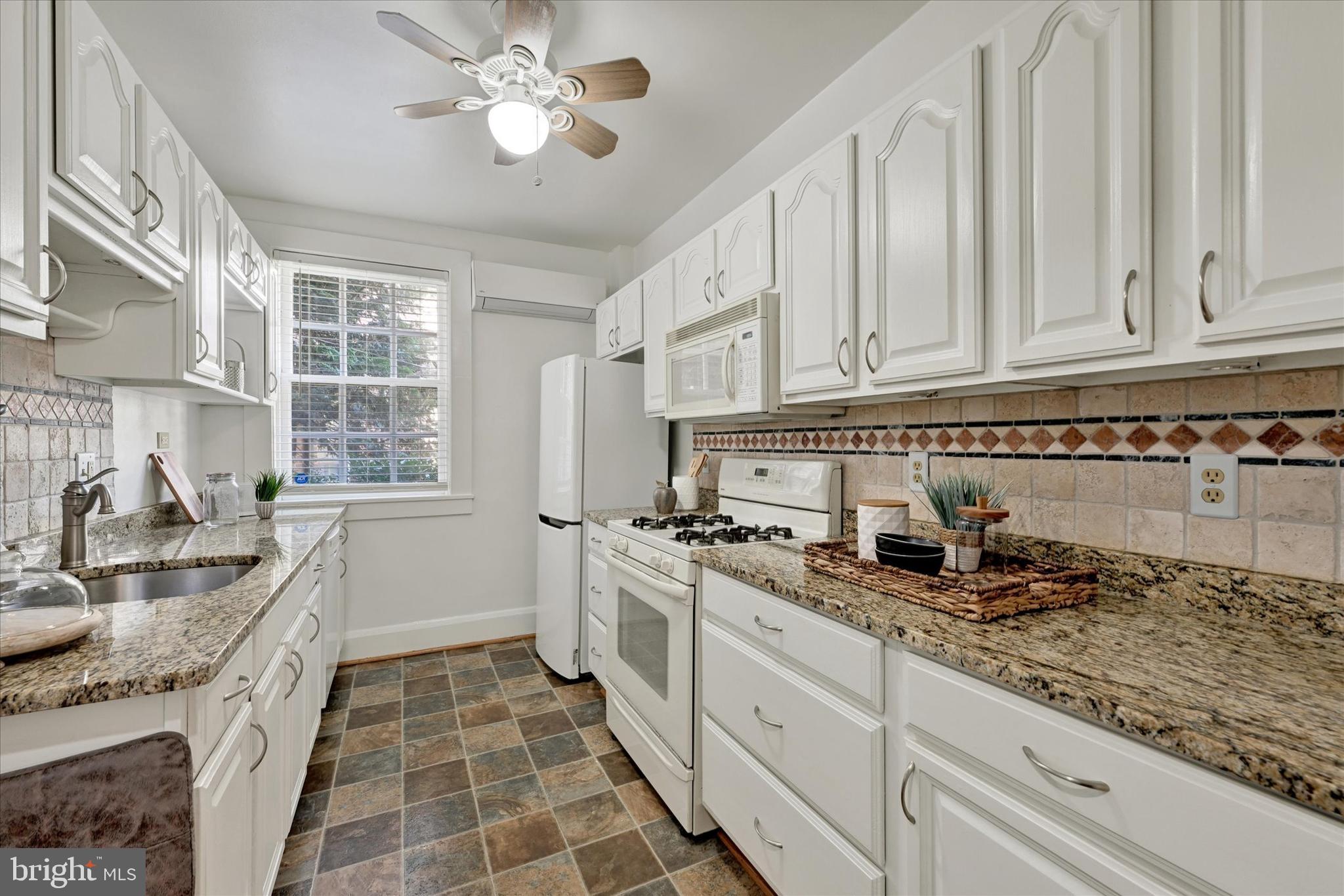 220 Stony Run Lane, Unit DG Baltimore, MD 21210 - Photo 5 of 13 a kitchen with stainless steel appliances granite countertop a sink stove and cabinets