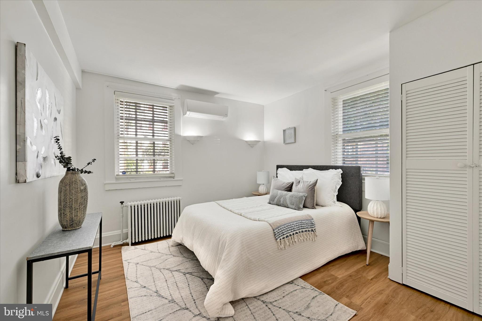 220 Stony Run Lane, Unit DG Baltimore, MD 21210 - Photo 7 of 13 a bedroom with a bed and a window