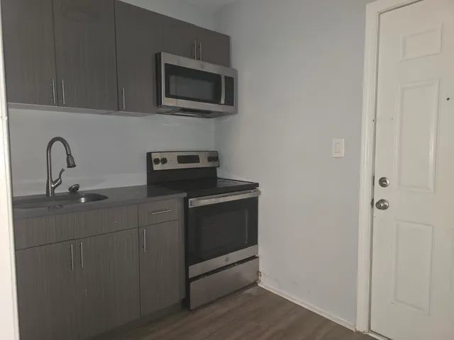 a kitchen with a sink and a microwave