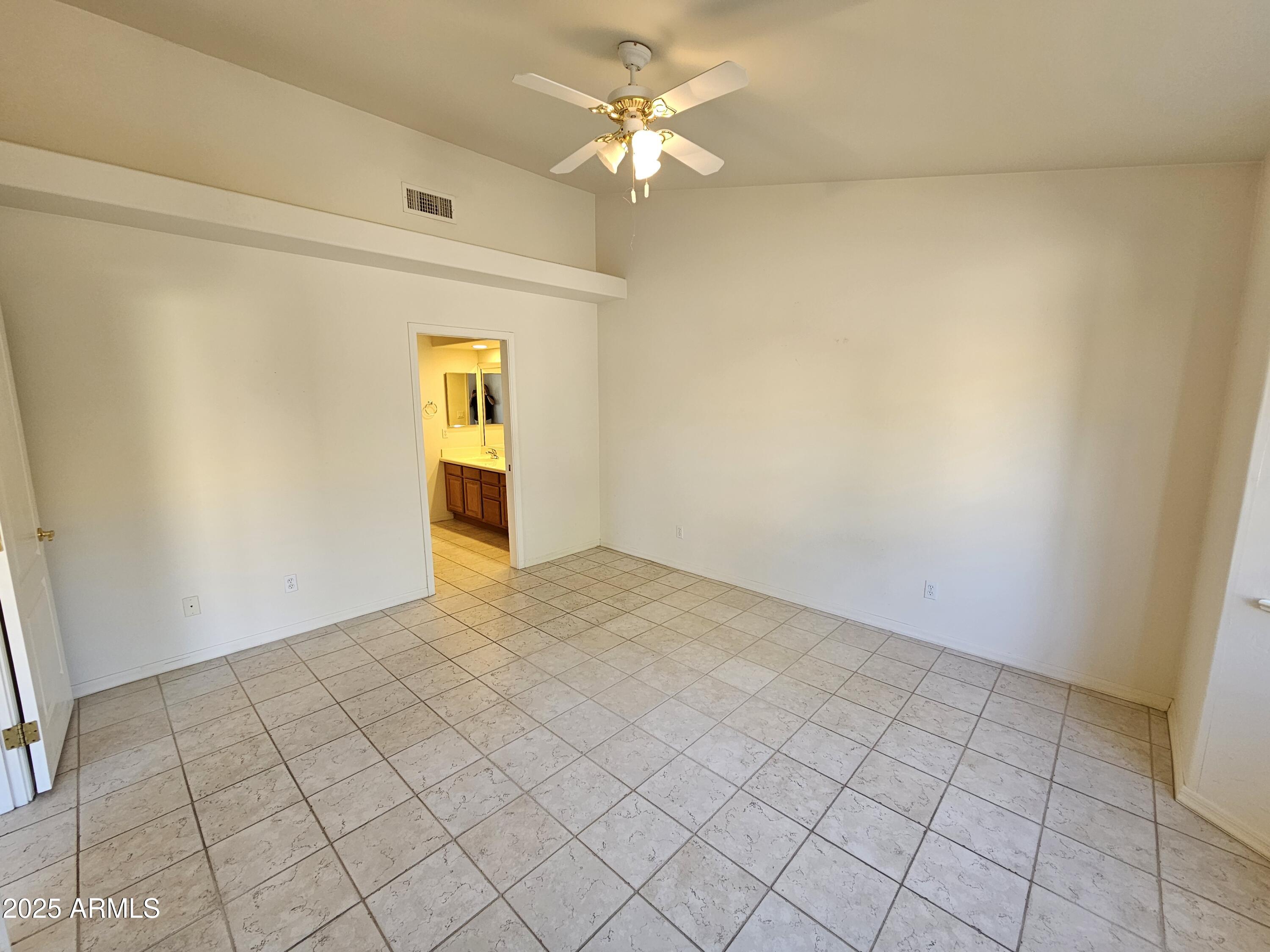 5830 East McKellips Road, Unit 139 Mesa, AZ 85215 - Photo 17 of 53 a view of an empty room and chandelier fan
