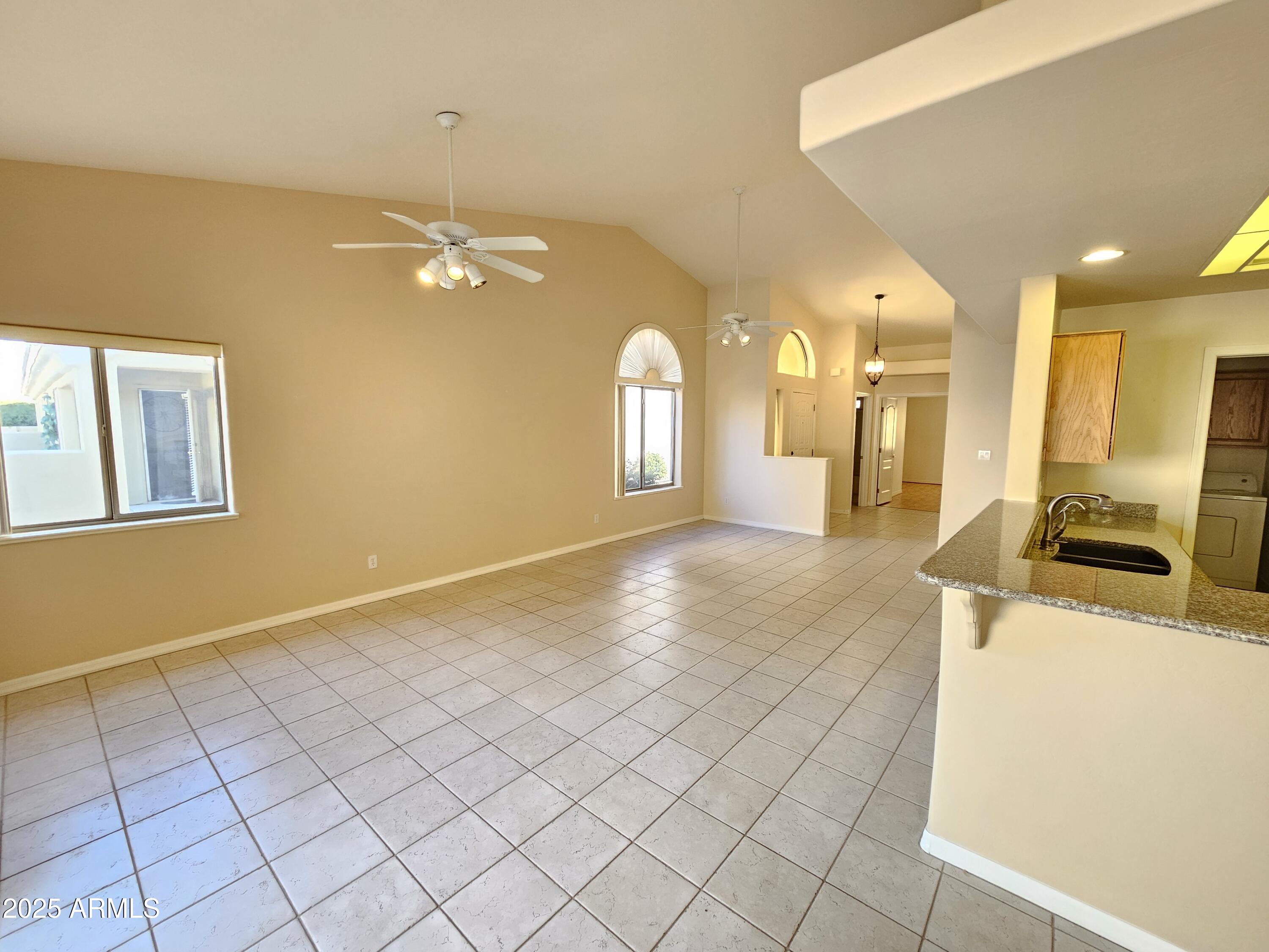 5830 East McKellips Road, Unit 139 Mesa, AZ 85215 - Photo 22 of 53 a view of a kitchen with kitchen island granite countertop cabinets and a stove