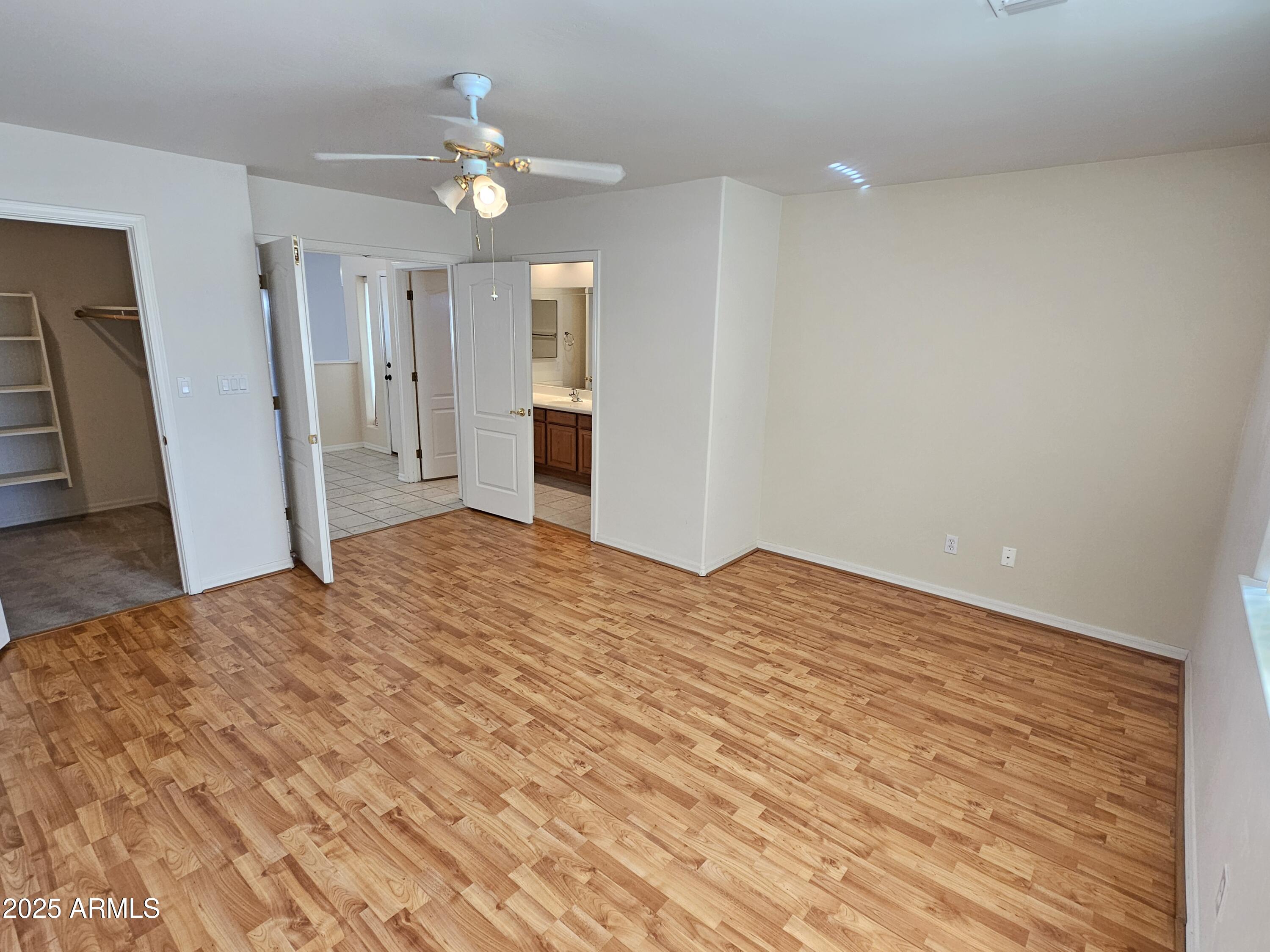 5830 East McKellips Road, Unit 139 Mesa, AZ 85215 - Photo 26 of 53 a bedroom with a bed and a dresser