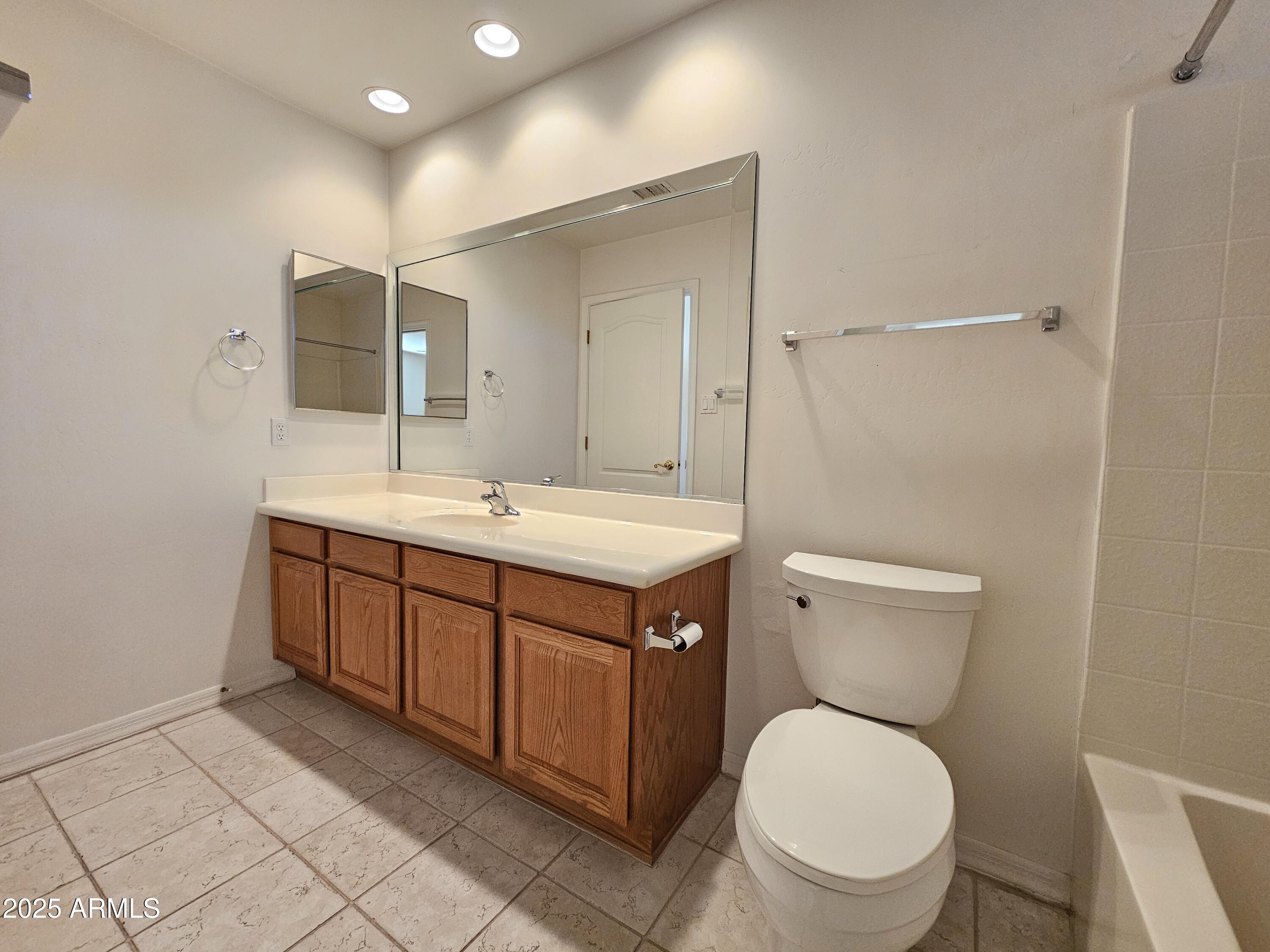 5830 East McKellips Road, Unit 139 Mesa, AZ 85215 - Photo 28 of 53 a bathroom with a toilet sink and mirror
