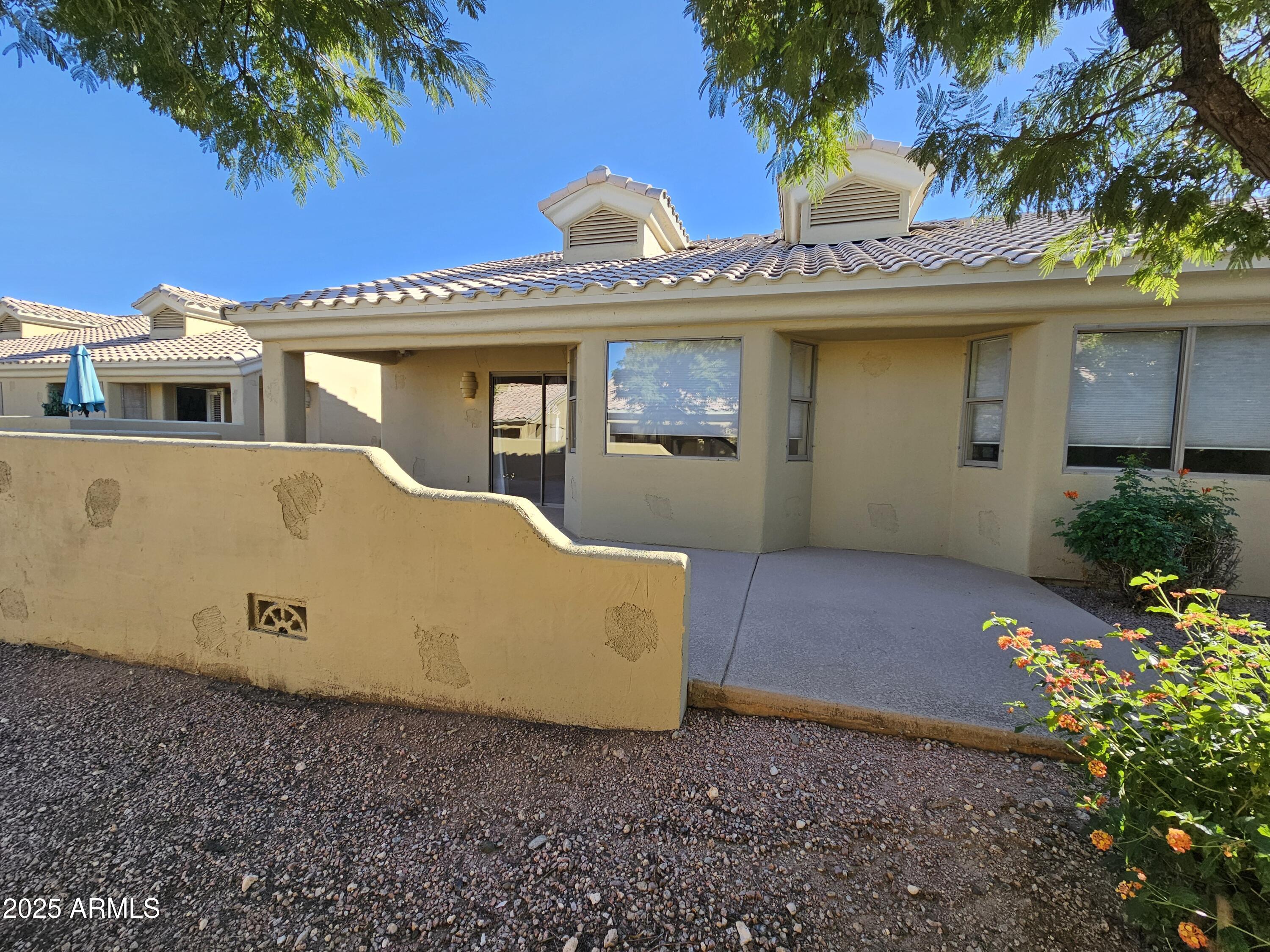 5830 East McKellips Road, Unit 139 Mesa, AZ 85215 - Photo 35 of 53 a front view of a house with a garden