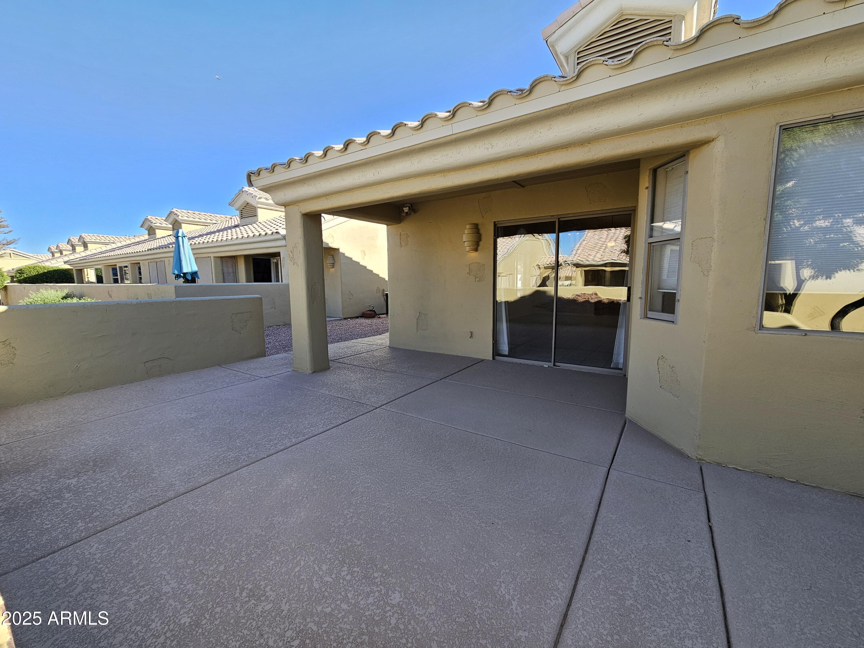 5830 East McKellips Road, Unit 139 Mesa, AZ 85215 - Photo 39 of 53 a view of a house with a barbeque and wooden stairs