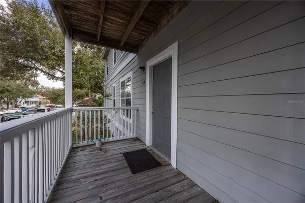 a view of a balcony with wooden floor