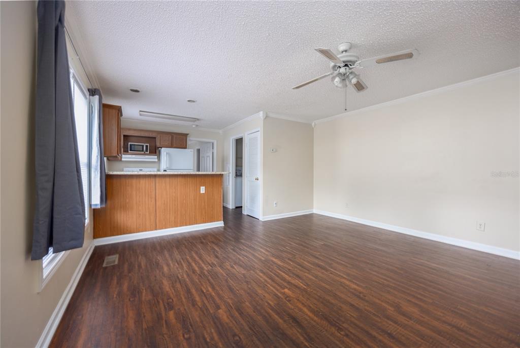 2905 Southwest Archer Road, Unit S4024 Gainesville, FL 32608 - Photo 4 of 19 wooden floor in an empty room with a window