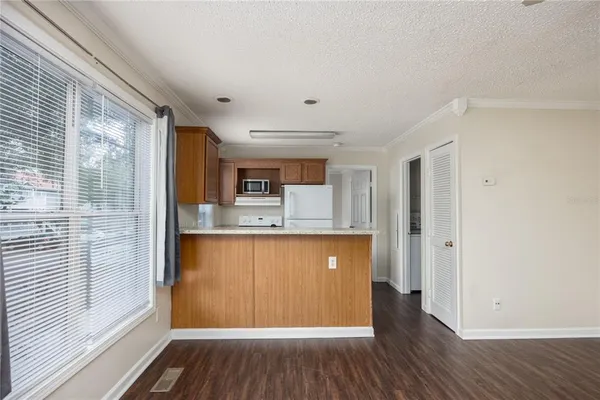 a view of a kitchen with wooden floor and a sink