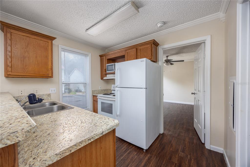 2905 Southwest Archer Road, Unit S4024 Gainesville, FL 32608 - Photo 9 of 19 a kitchen with a refrigerator and a sink