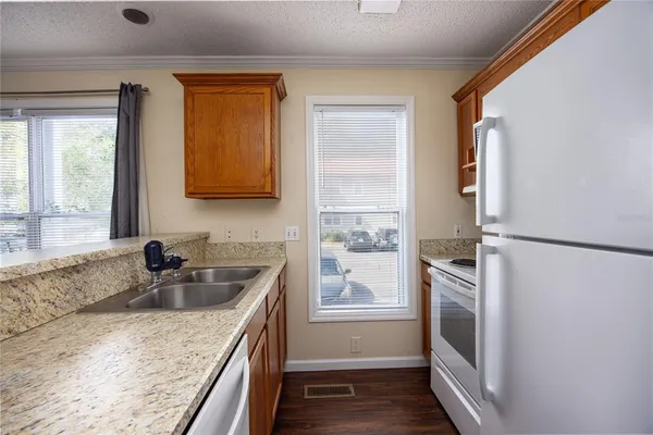 a kitchen with a sink stove and refrigerator