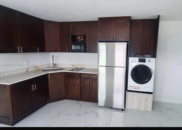 a kitchen with wooden cabinets a sink and a stove