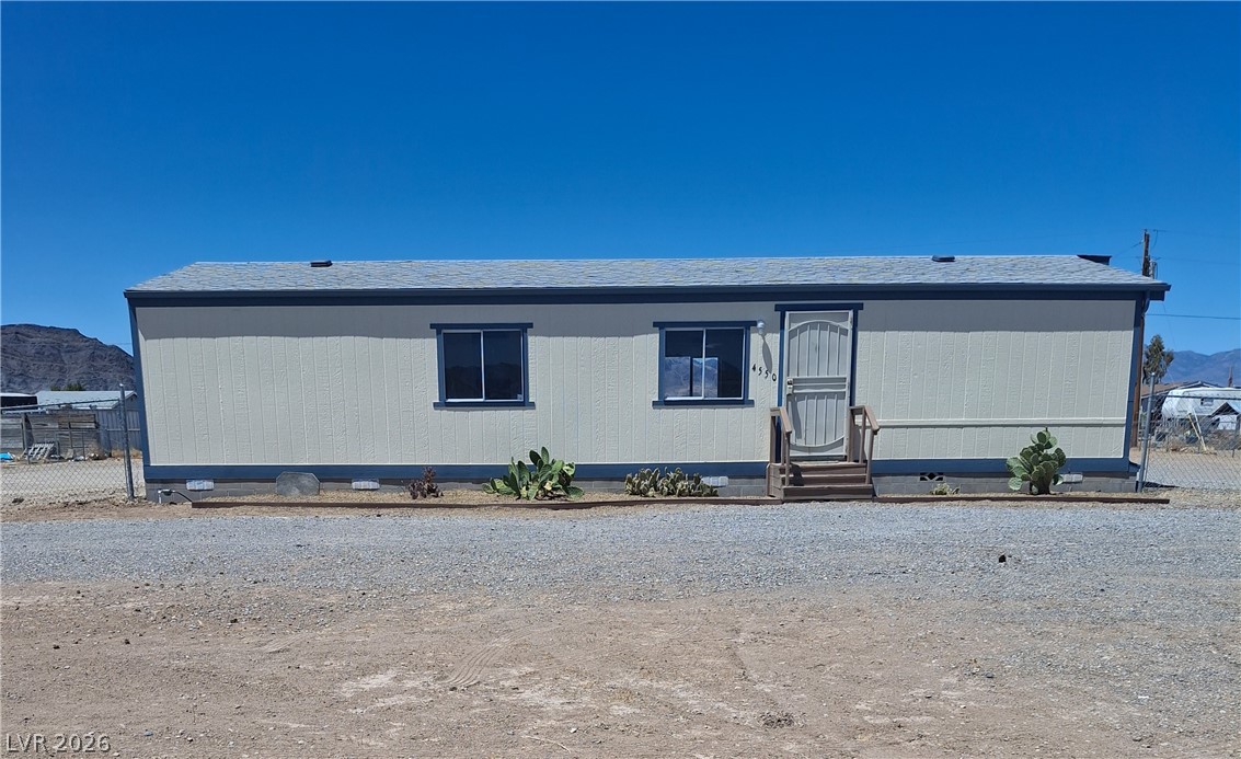 A well-maintained single-story dwelling stands ready for new occupants, offering clear desert sky views.