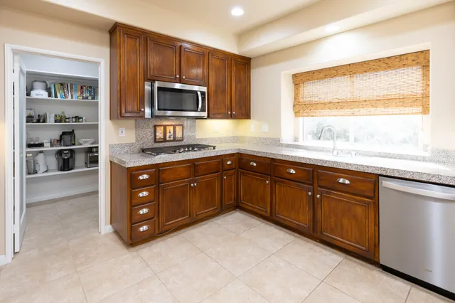 a view of a dining room with furniture and a potted plant
