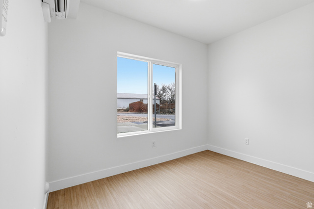 2085 North Main Street, Unit 301 Sunset, UT 84015 - Photo 8 of 20 Bed roomroom featuring baseboards and light wood-type flooring