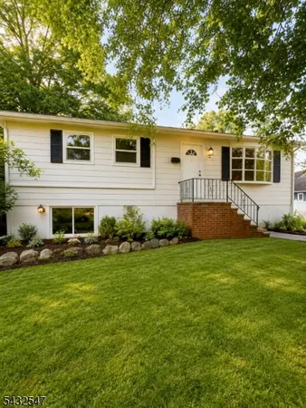 a view of a house with a backyard