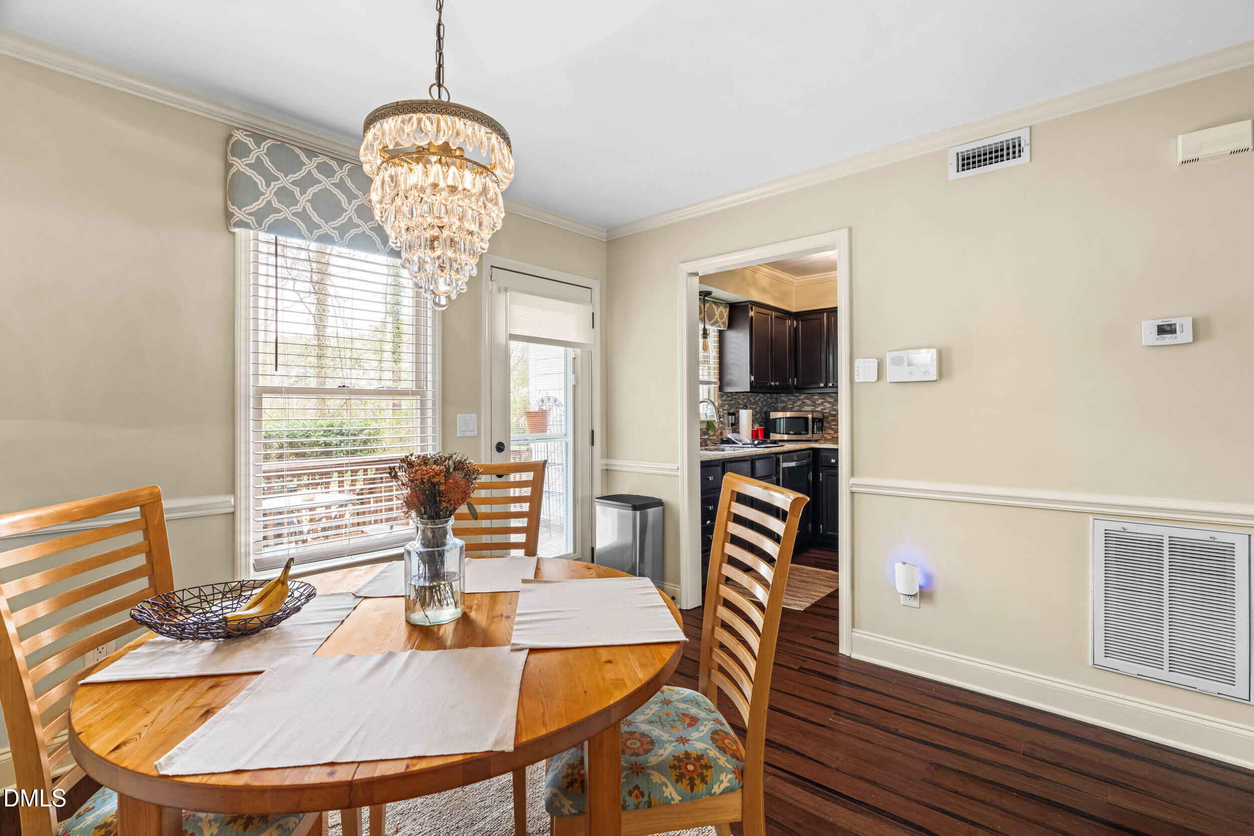 710 Powell Drive, Unit C Raleigh, NC 27606 - Photo 12 of 35 a view of a dining room with furniture wooden floor and chandelier