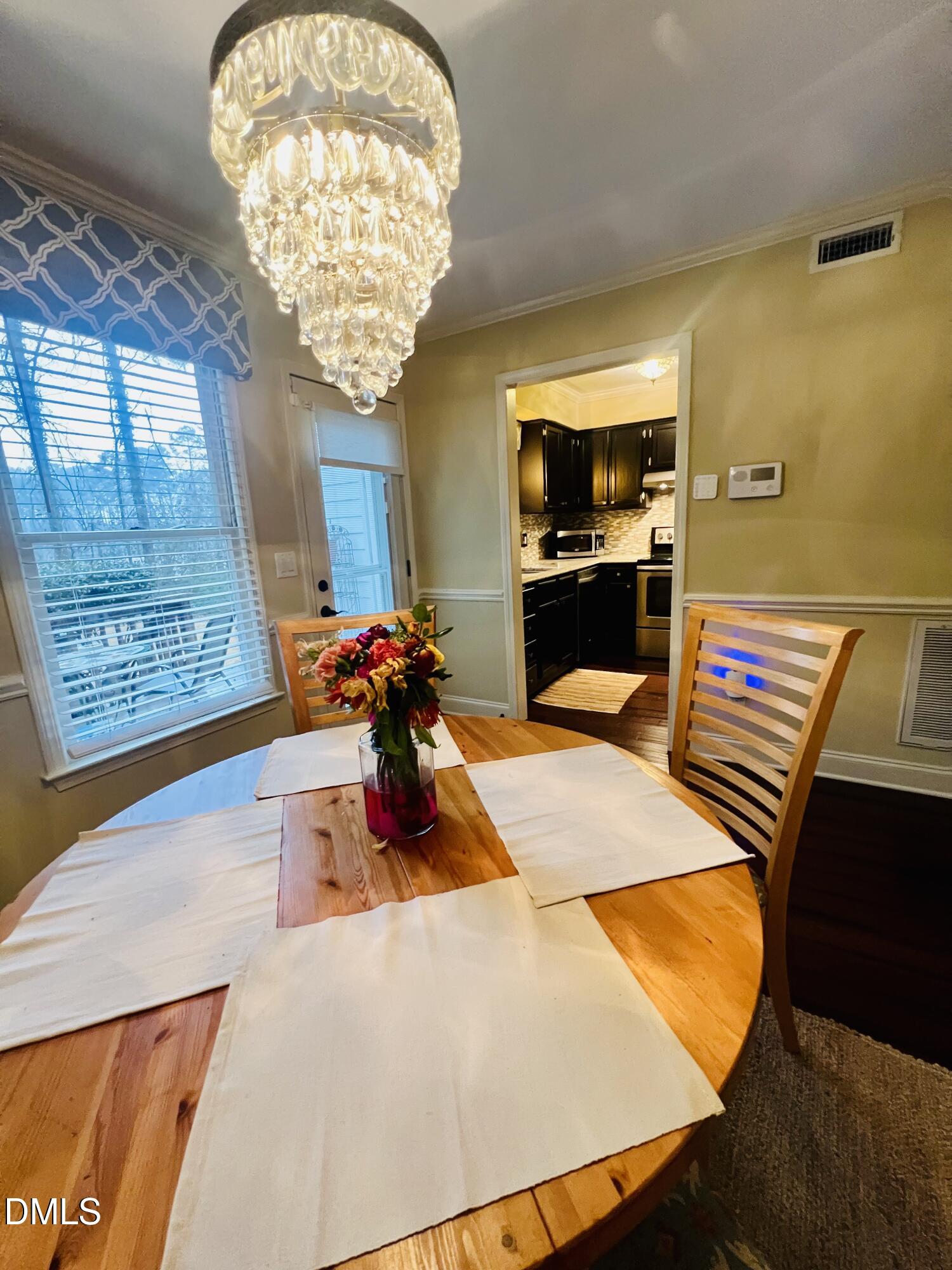 710 Powell Drive, Unit C Raleigh, NC 27606 - Photo 14 of 35 a living room with furniture and a chandelier
