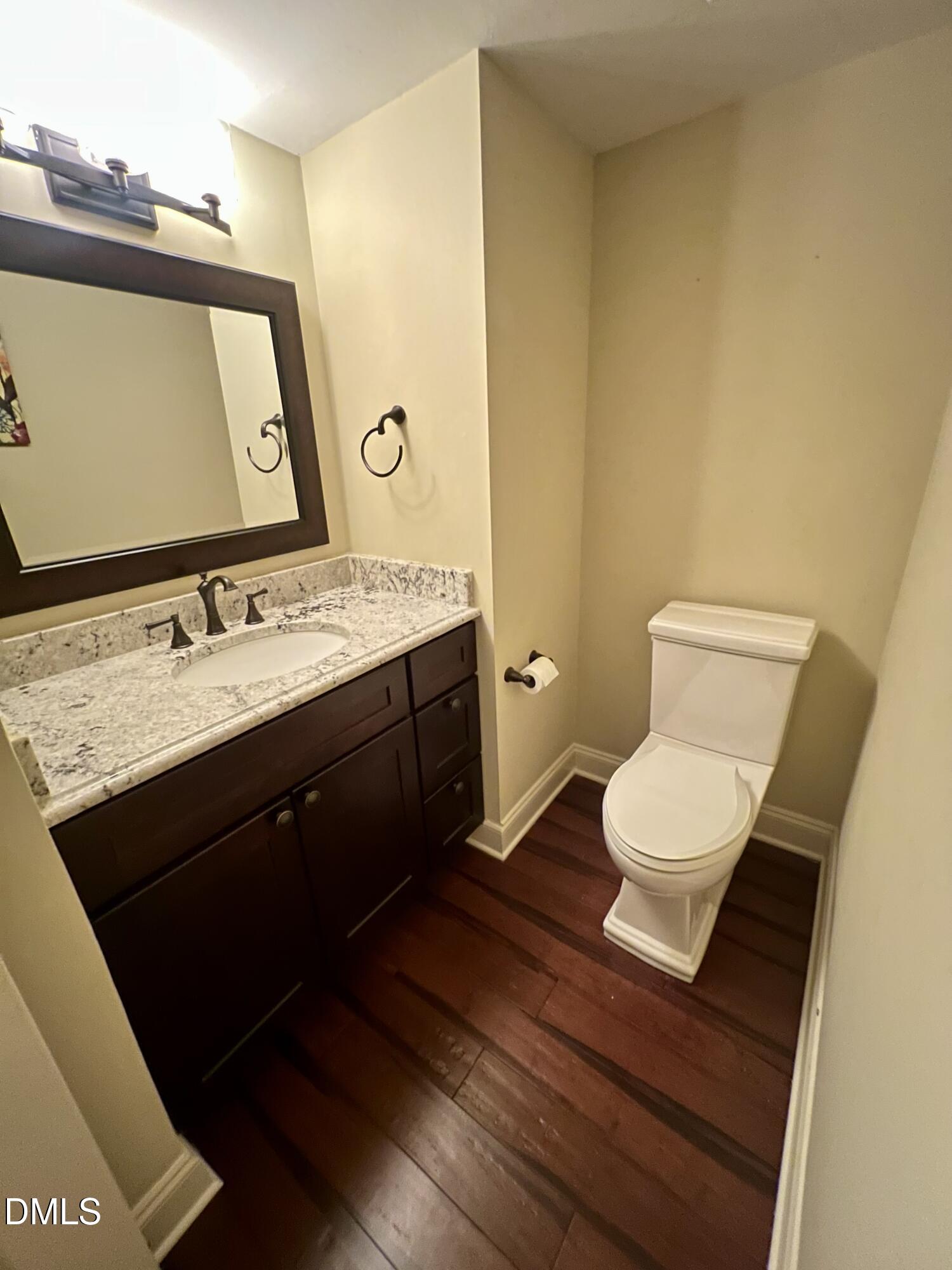710 Powell Drive, Unit C Raleigh, NC 27606 - Photo 17 of 35 a bathroom with a sink and a mirror