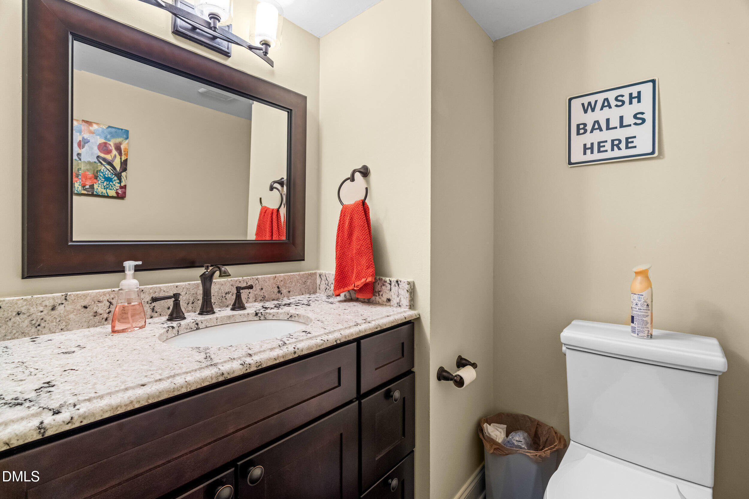 710 Powell Drive, Unit C Raleigh, NC 27606 - Photo 19 of 35 a bathroom with a granite countertop sink a toilet and a mirror