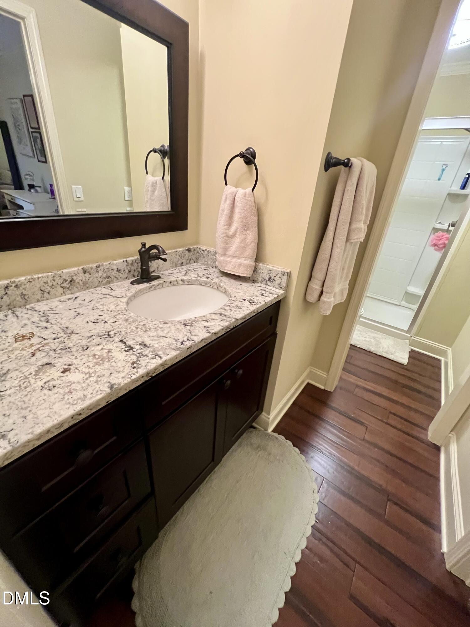 710 Powell Drive, Unit C Raleigh, NC 27606 - Photo 25 of 35 a bathroom with a sink and a mirror