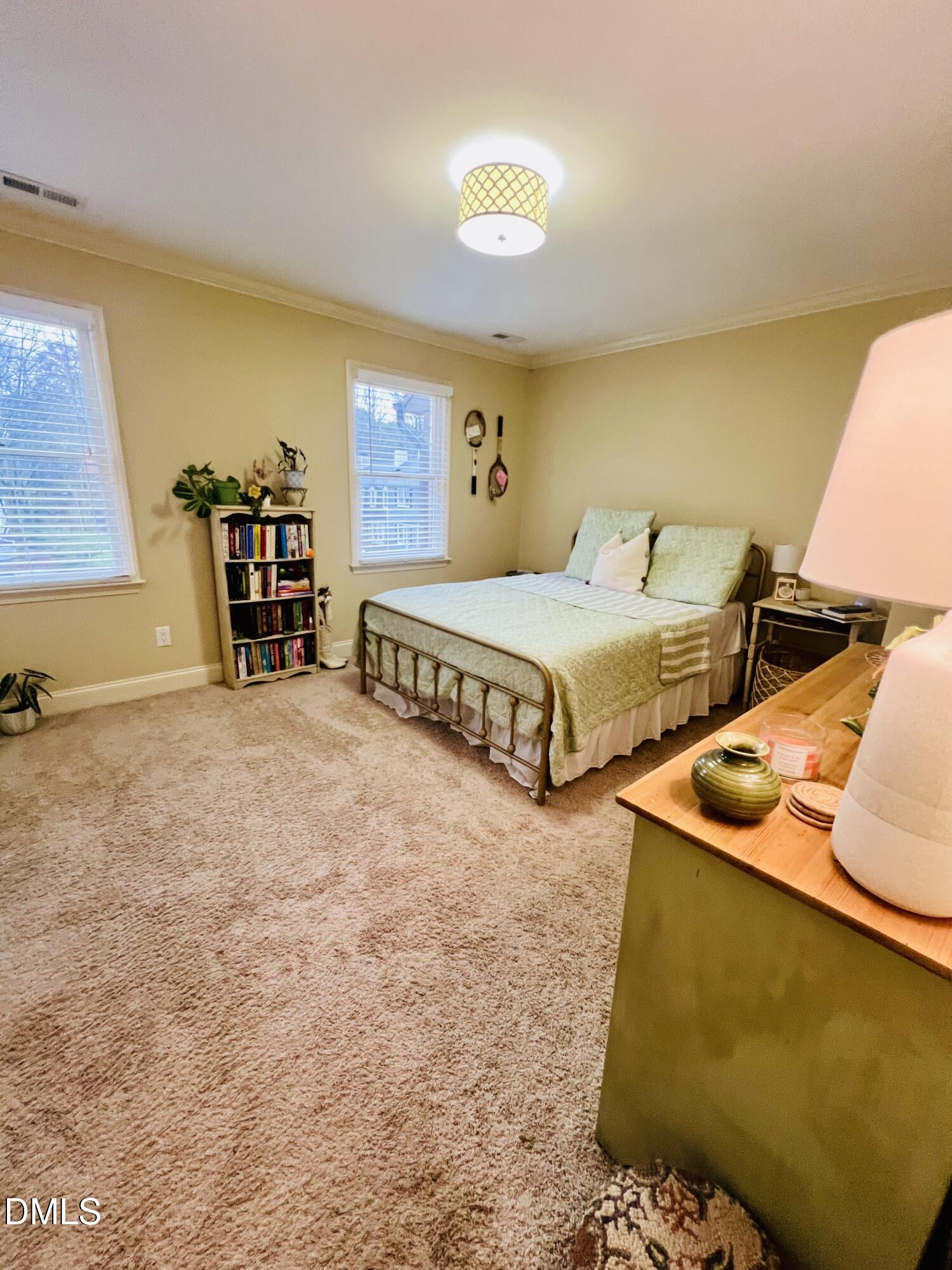 710 Powell Drive, Unit C Raleigh, NC 27606 - Photo 27 of 35 a spacious bedroom with two beds and a lamp