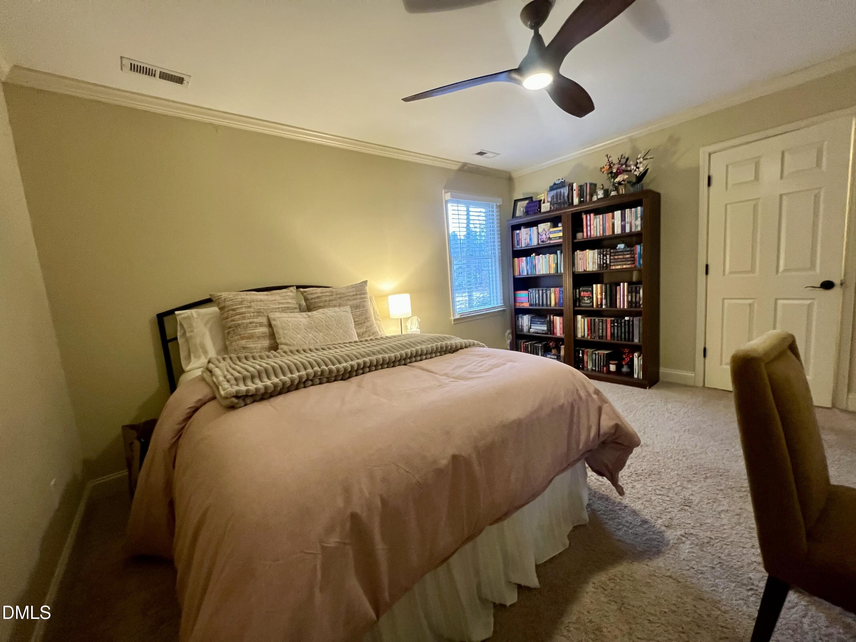710 Powell Drive, Unit C Raleigh, NC 27606 - Photo 29 of 35 a bedroom with a bed furniture and a window
