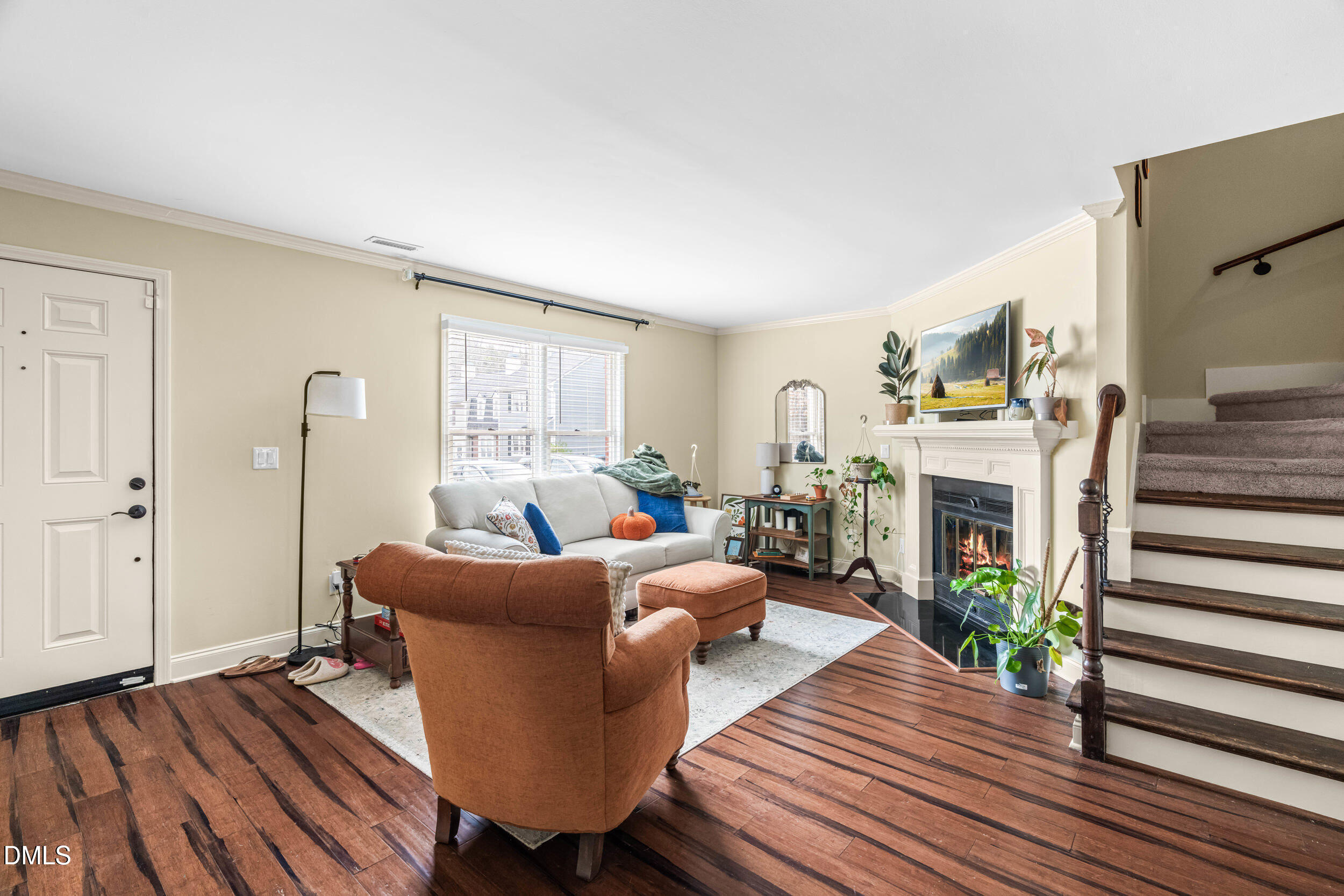 710 Powell Drive, Unit C Raleigh, NC 27606 - Photo 5 of 35 a living room with furniture a fireplace and wooden floor