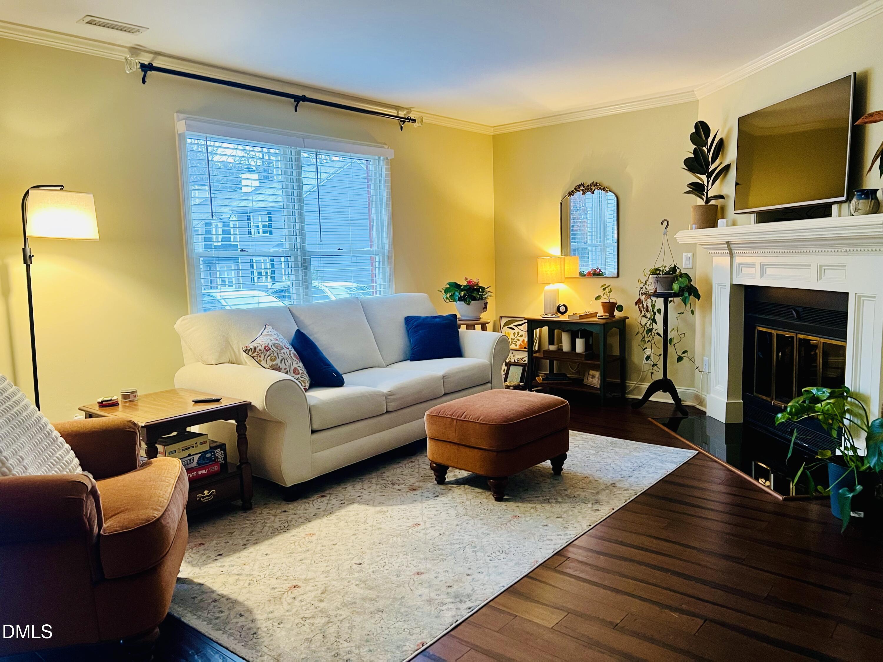 710 Powell Drive, Unit C Raleigh, NC 27606 - Photo 10 of 35 a living room with furniture fireplace and flat screen tv