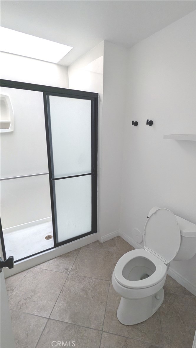 718 Vía La Paloma Riverside, CA 92507 - Photo 14 of 26 a bathroom with a toilet a sink and a mirror