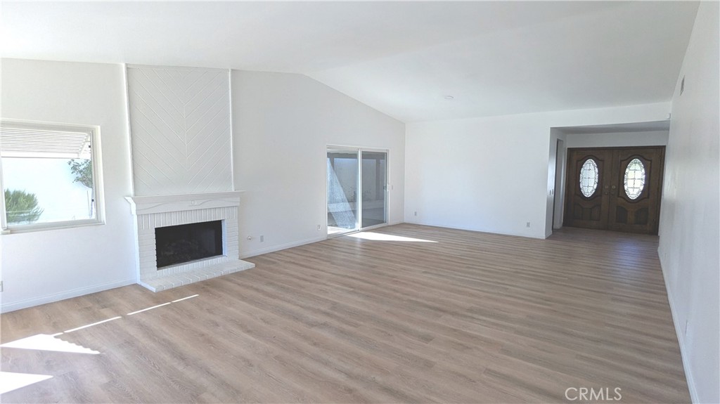 718 Vía La Paloma Riverside, CA 92507 - Photo 4 of 26 a view of a livingroom with wooden floor and a fireplace