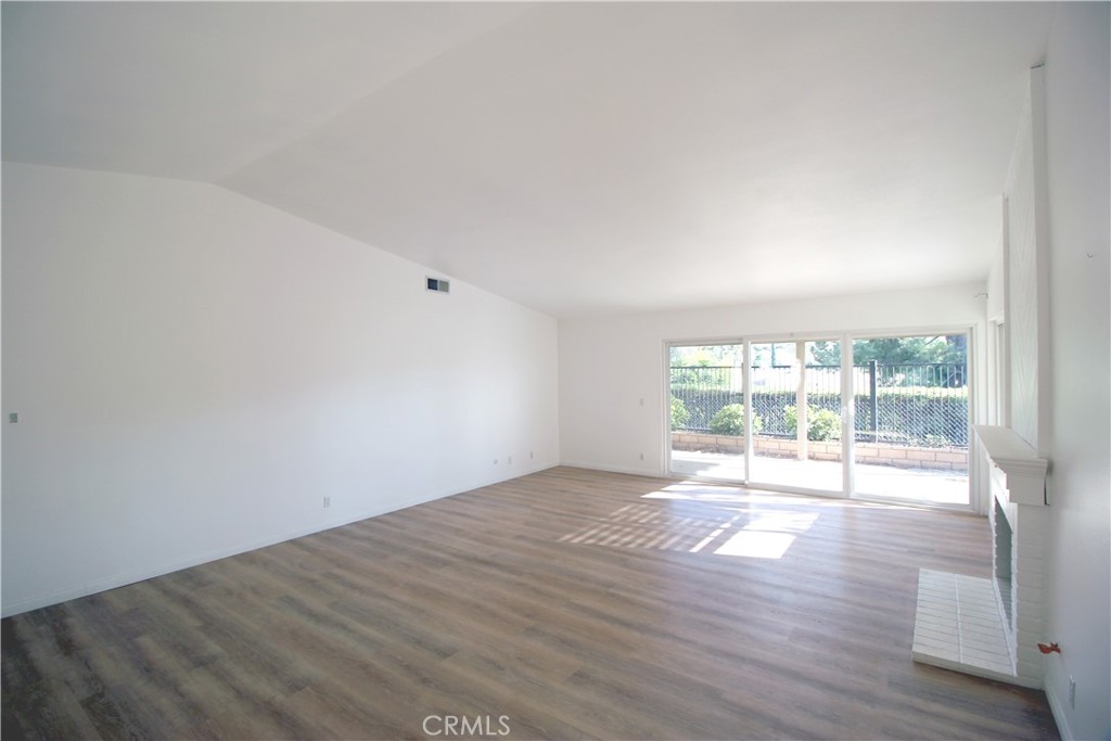 718 Vía La Paloma Riverside, CA 92507 - Photo 5 of 26 a view of an empty room with wooden floor and a window