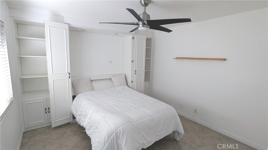 718 Vía La Paloma Riverside, CA 92507 - Photo 6 of 26 a bedroom with a bed and a chandelier