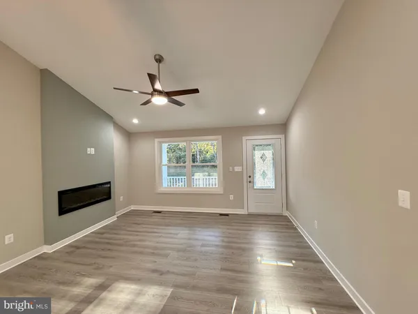 a view of a living room and a kitchen with a sink