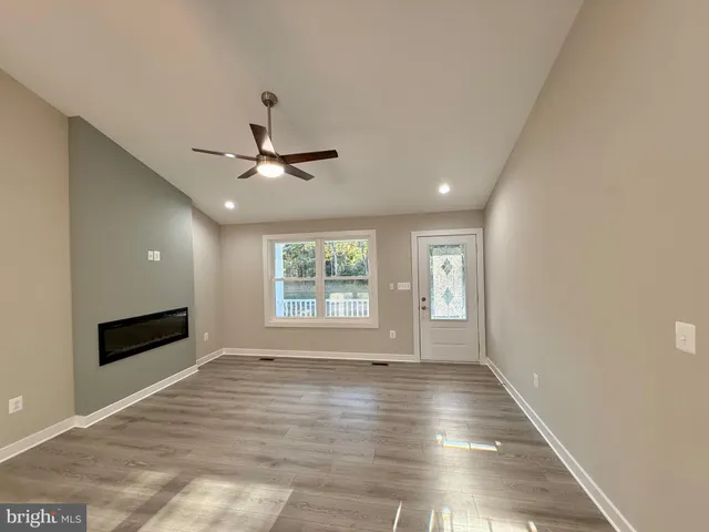 a view of a living room and a kitchen with a sink