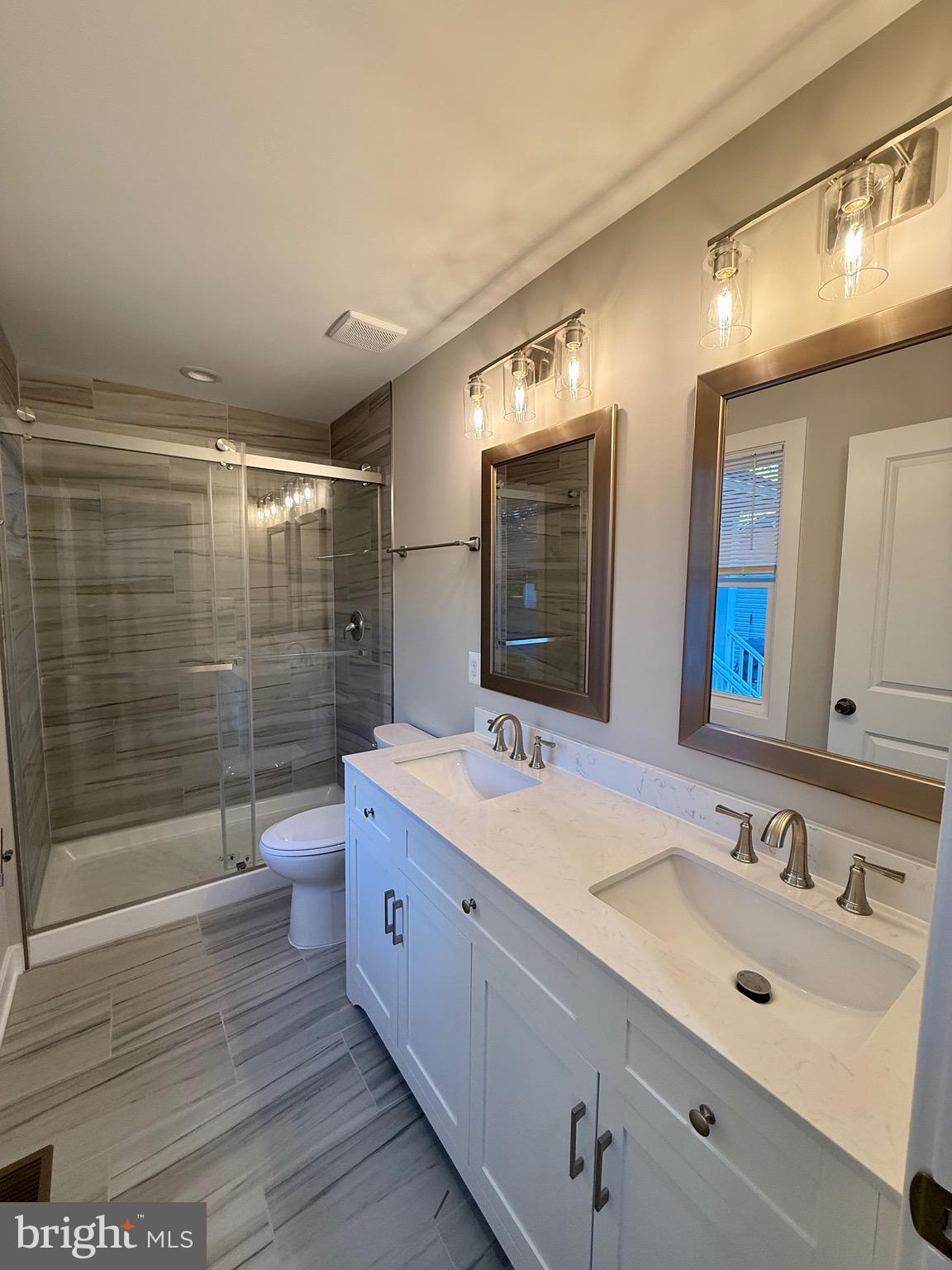 Tbd Lot 184 Tbd Montross, VA 22520 - Photo 15 of 64 a bathroom with a double vanity sink mirror double shower and a toilet