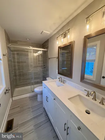 a bathroom with double vanity sinks and a mirror