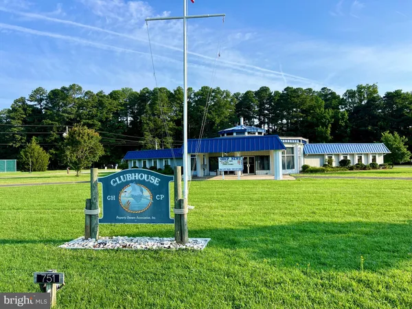 a view of a backyard with swimming pool and furniture