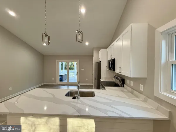 a view of a kitchen with a sink and a fireplace