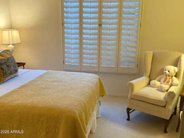a bedroom with a bed and a chair