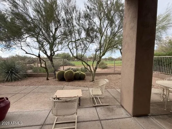 a patio with couches and a fire pit