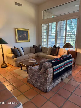 a living room with furniture and a floor to ceiling window