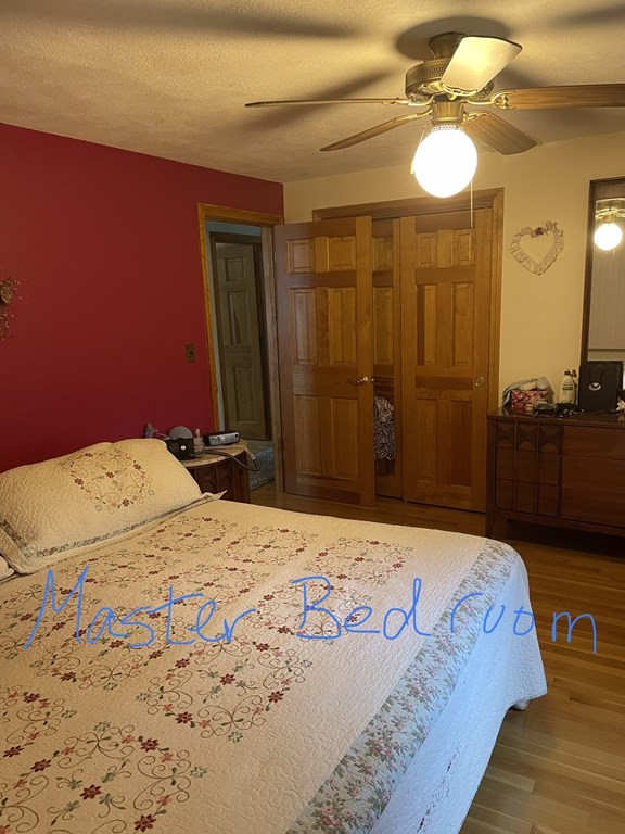 54 Charme Road Billerica, MA 01821 - Photo 11 of 23 a bedroom with a bed and a chandelier