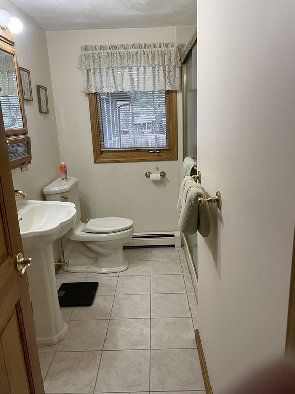 54 Charme Road Billerica, MA 01821 - Photo 15 of 23 a bathroom with a toilet sink and mirror