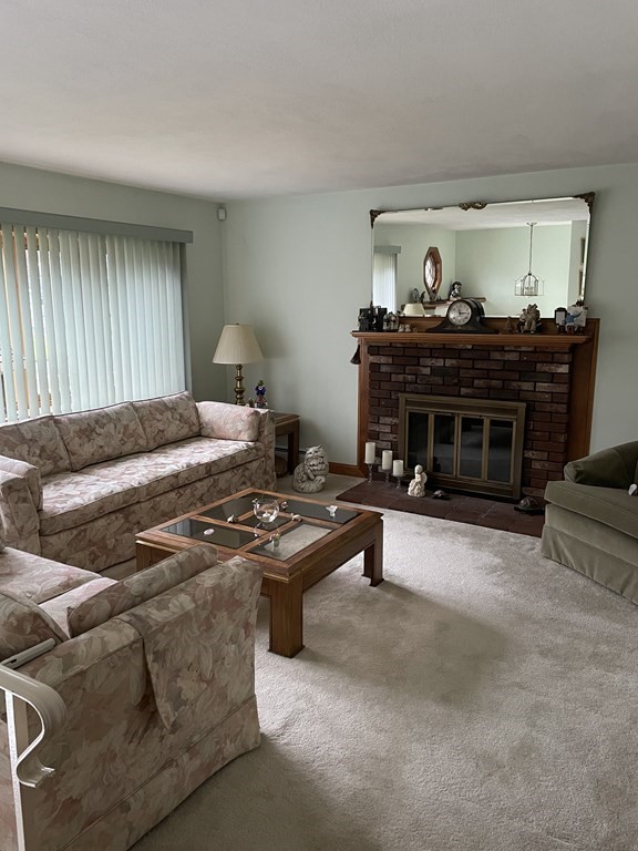 54 Charme Road Billerica, MA 01821 - Photo 2 of 23 a living room with furniture and a flat screen tv