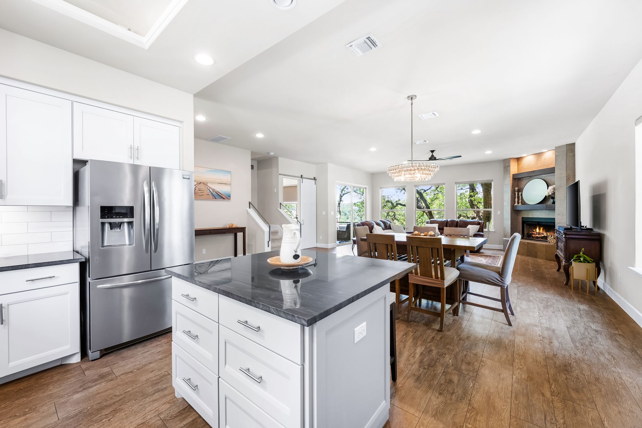 14213 Red Feather Trail Austin, TX 78734 - Photo 14 of 39 a kitchen with stainless steel appliances granite countertop a refrigerator a sink a stove and white cabinets with wooden floor
